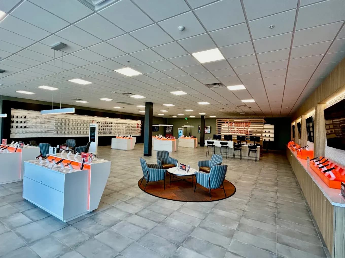 Consumer Cellular Fort Myers sales floor with display islands, customer seating and branded counter