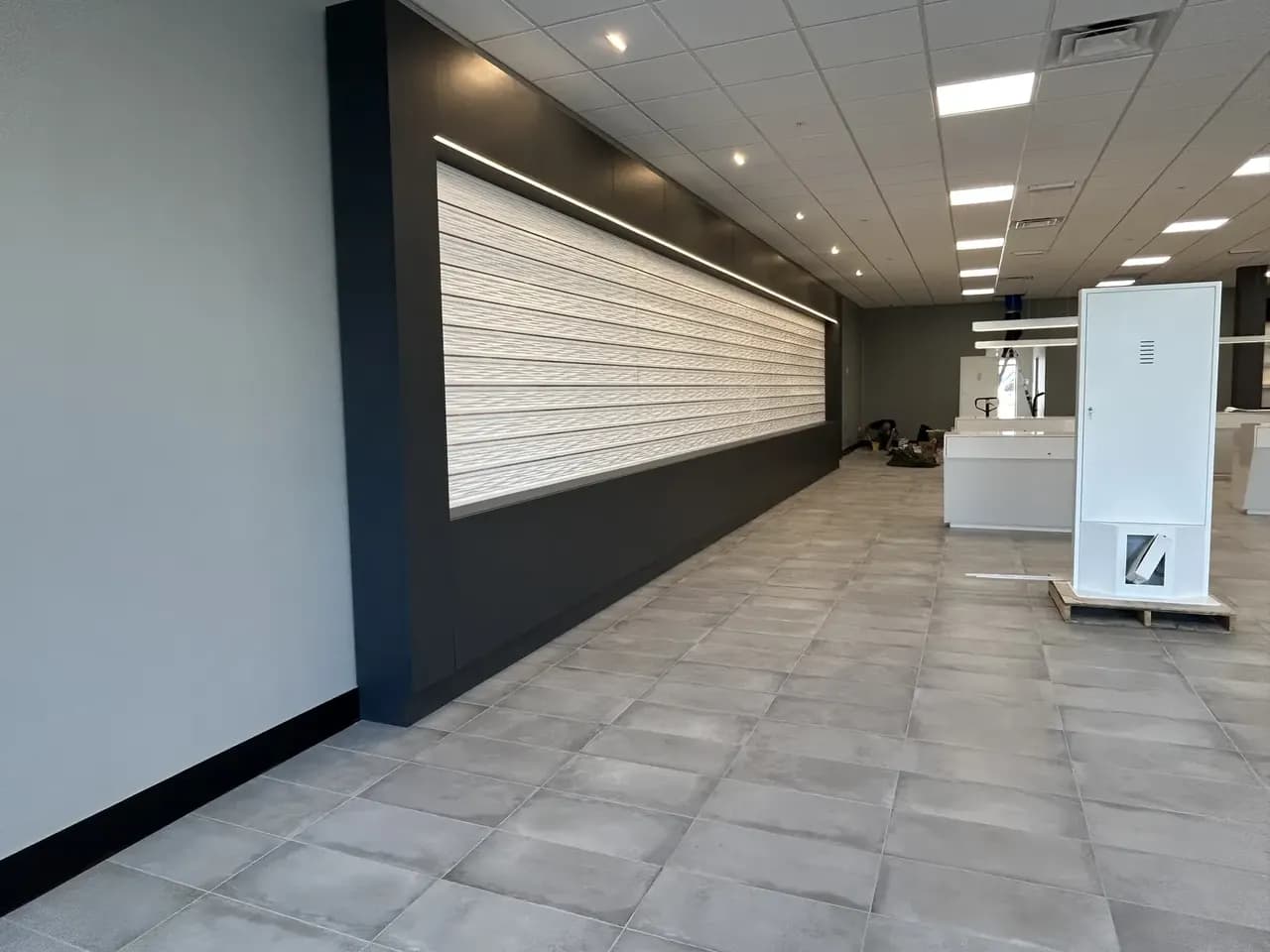 Tile flooring, finished walls and partially installed displays in the Consumer Cellular Fort Myers interior