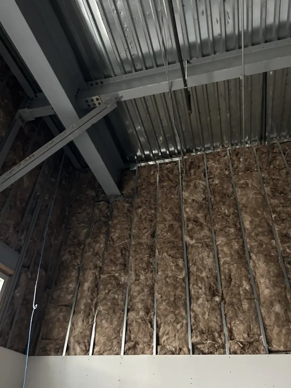 Wall insulation and exposed overhead structure during the Consumer Cellular Fort Myers build-out
