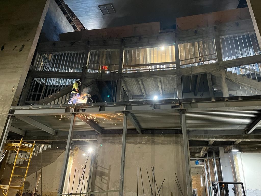Commercial structural steel installation underway inside an existing building