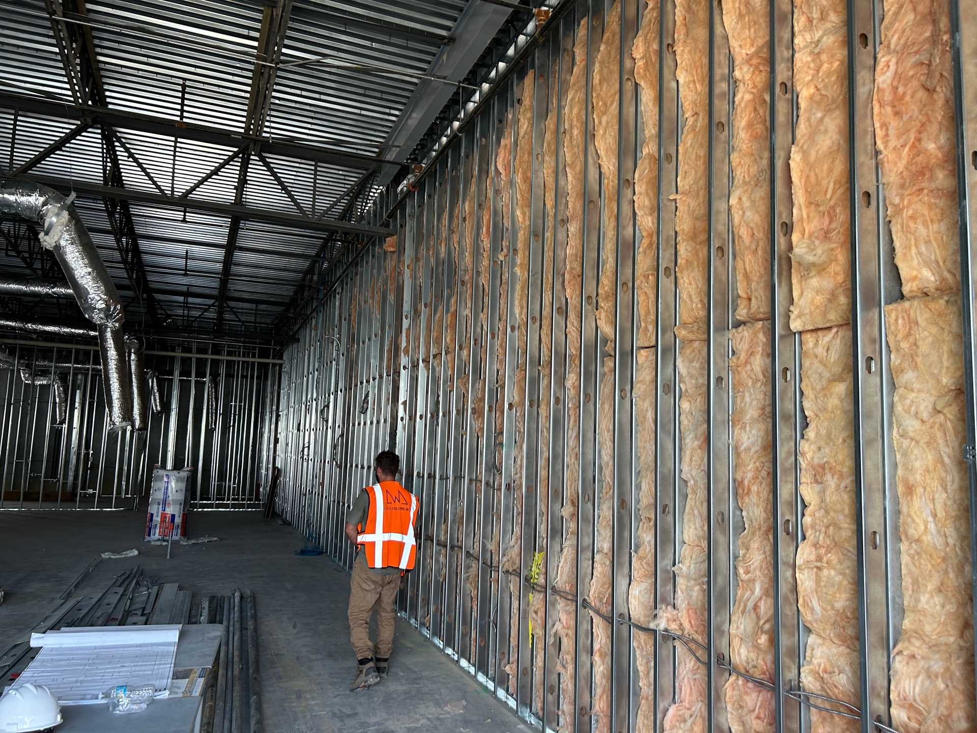 DWD Builders commercial interior construction with insulation, metal framing, and overhead building systems