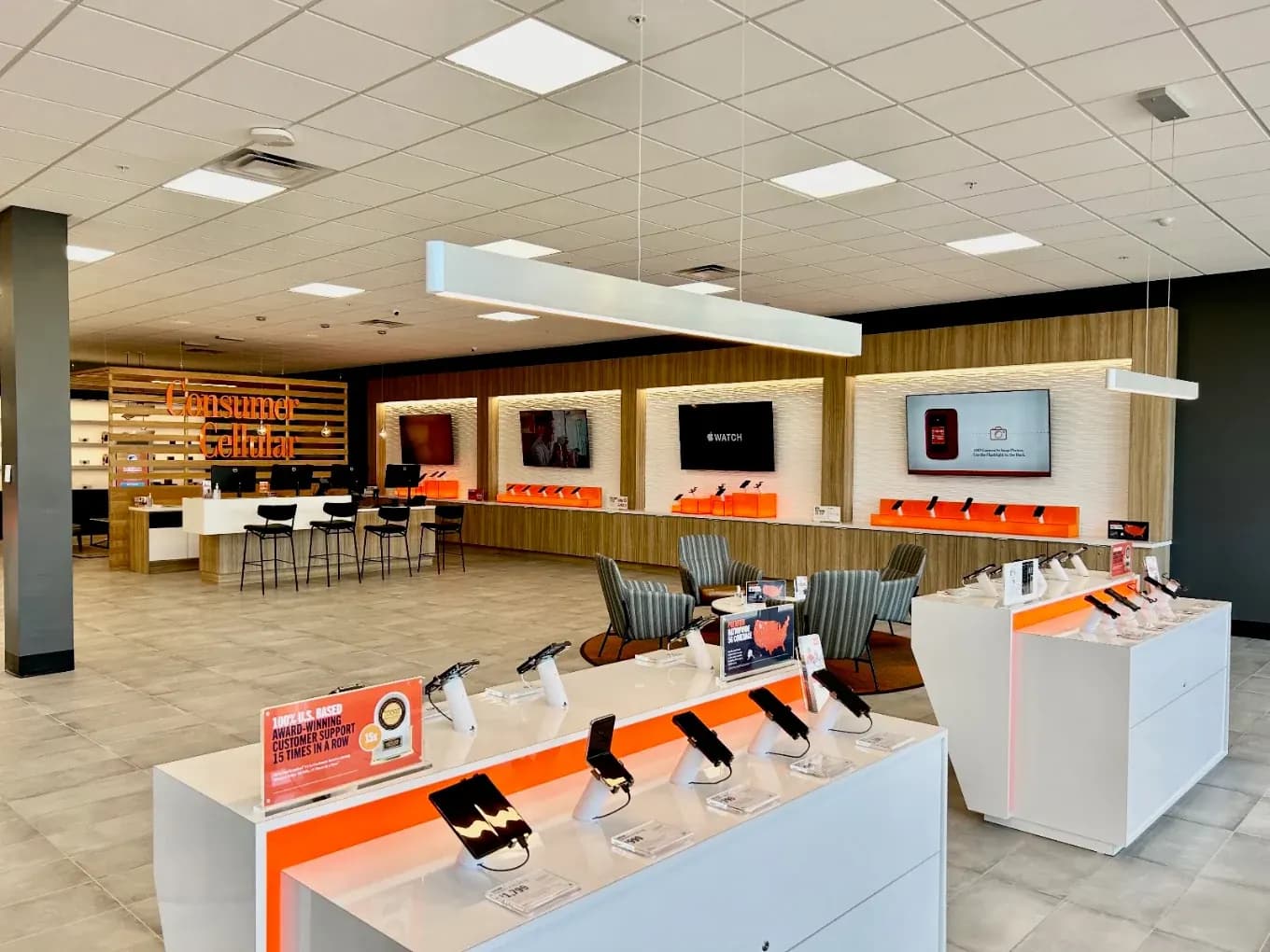 Completed Consumer Cellular Fort Myers interior with phone displays, illuminated feature walls and consultation counter