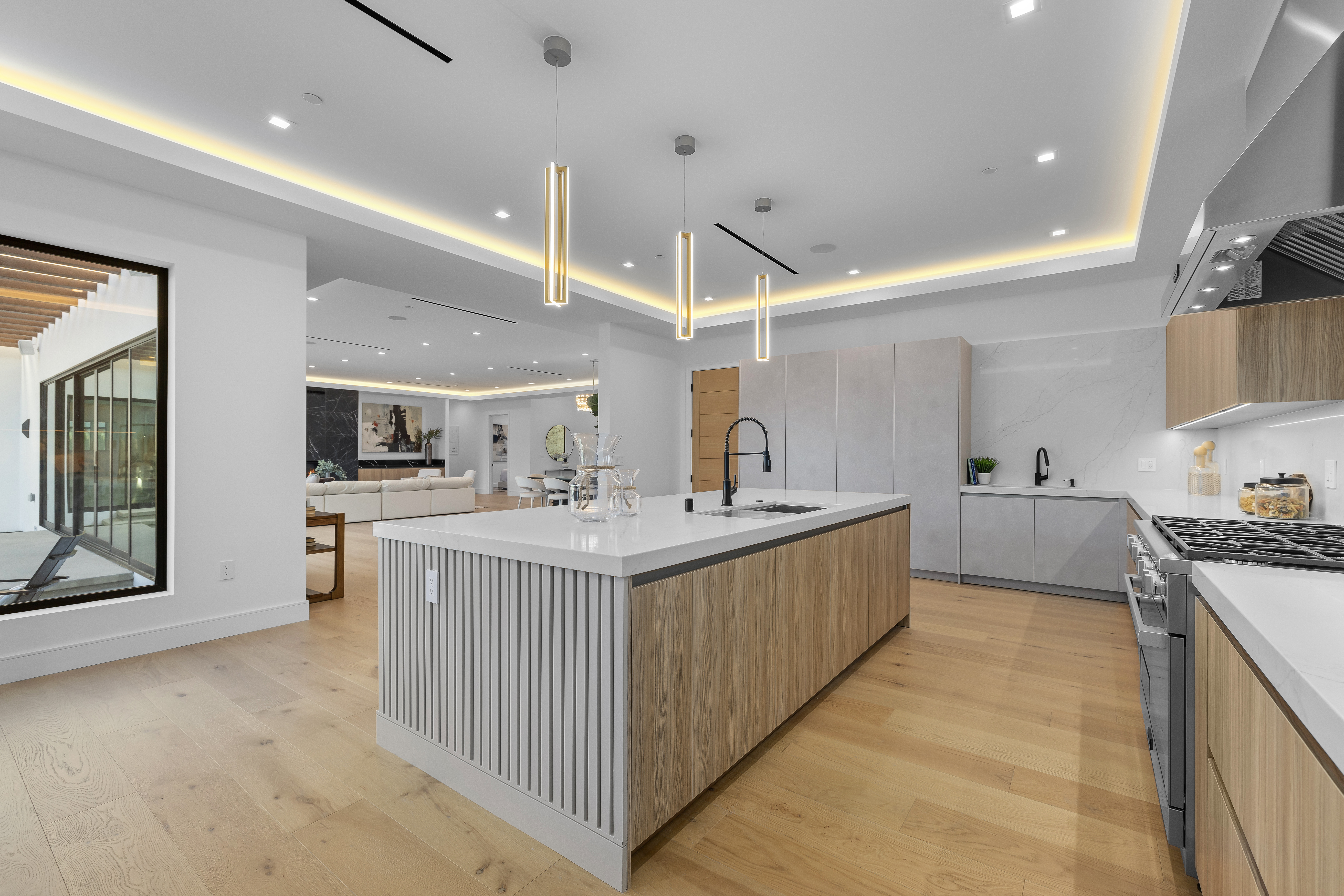 Custom kitchen with large island and pendant lighting — DWD Builders
