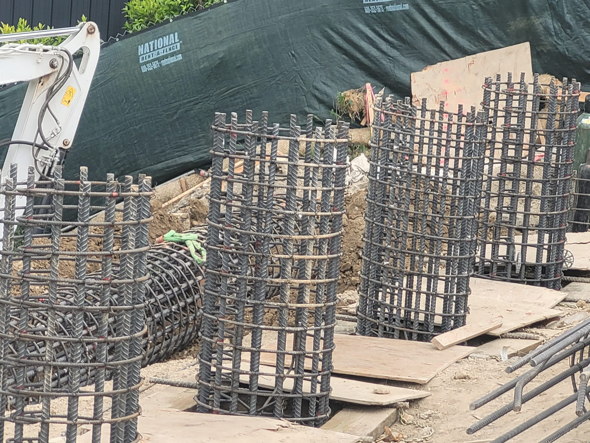 Caisson rebar cages staged for hillside foundation — DWD Builders 2026