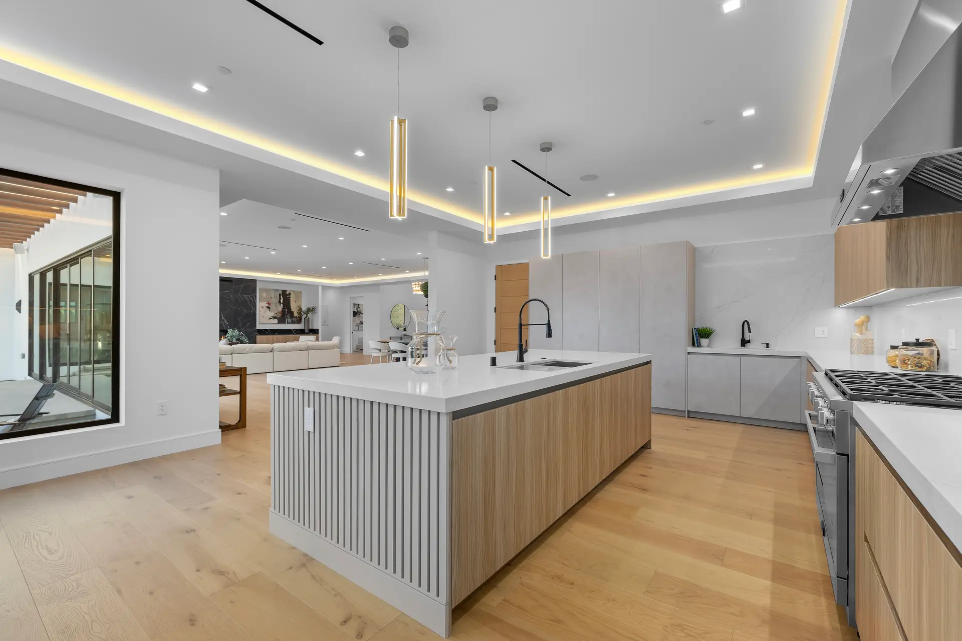 Custom kitchen with large island and pendant lighting — DWD Builders