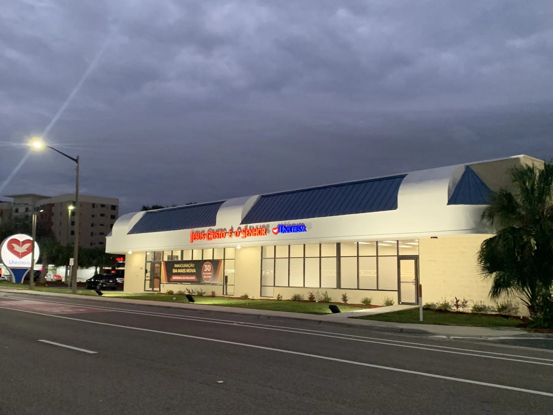 Completed Exterior — Main Entrance and Illuminated Façade